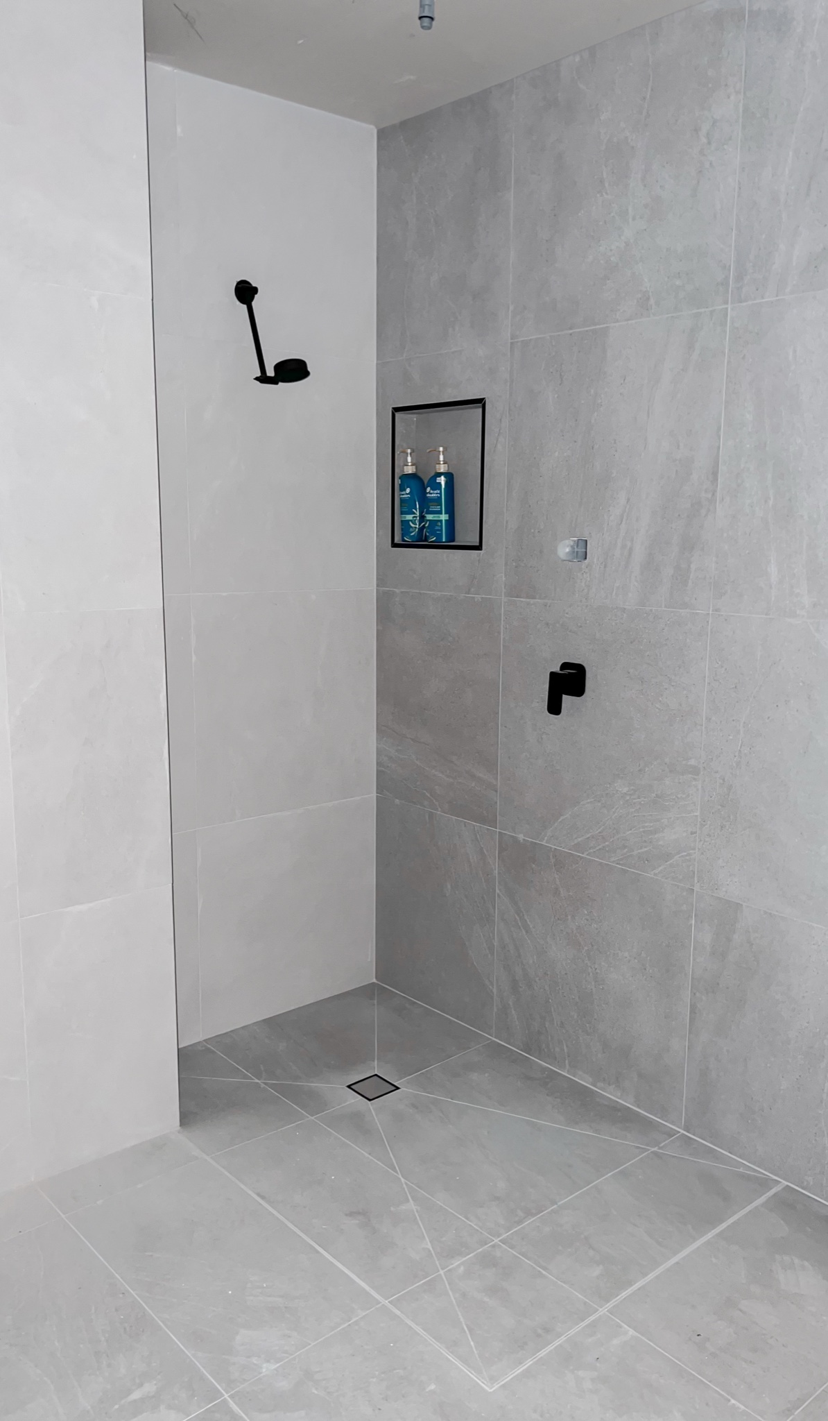 Grey stone-look bathroom, wide view