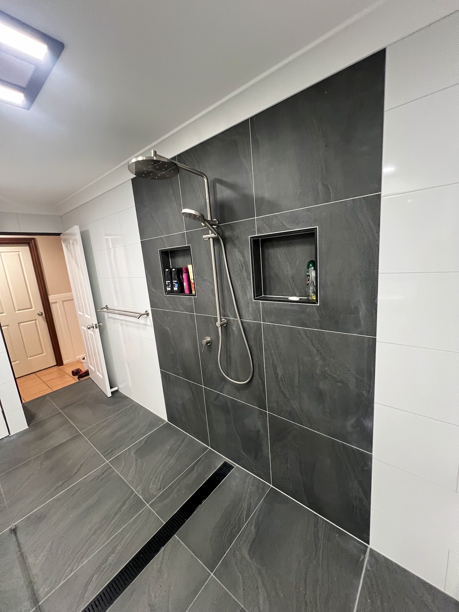 Shower with charcoal feature wall, rain head and separate handheld set